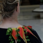 A collar of red Heliconia flowers is a sure way to spruce up any black outfit.